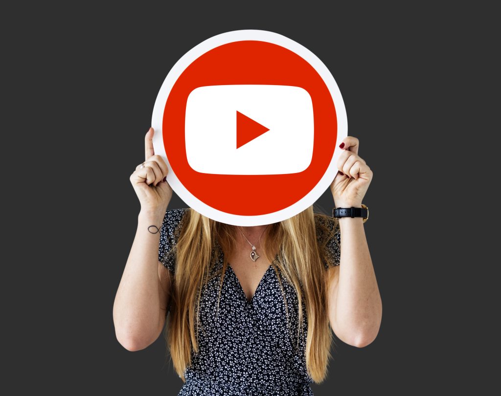 Woman holding a YouTube icon